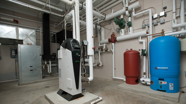 A geothermal system cools the building in the summer and heats the makeup fresh air supplied to the building.